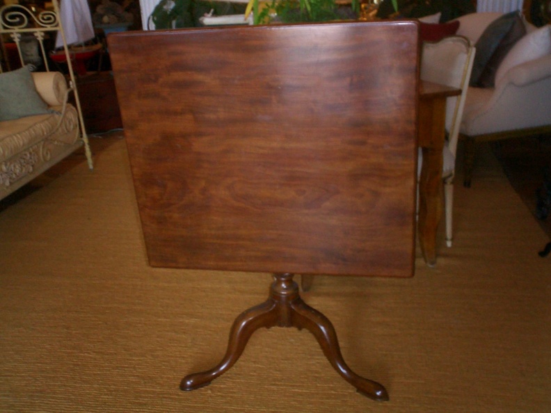 Antique mahogany tilt-top pedestal table.  Approximately 48" square.