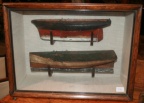 Antique boat hulls in early paint encased in glass display box