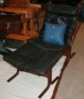 Ingmar Relling "siesta" black leather lounge chair with matching ottoman.  Both with walnut wood base