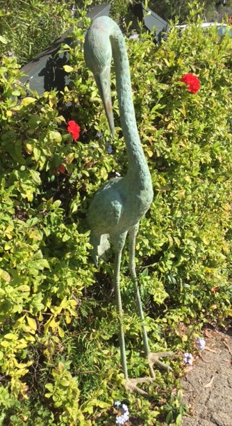 Statuesque Bronze Crane  The crane is a symbol of happiness, eternal youth and good fortune because of the bird's fabled life span of a thousand years.  Measuring 5 1/2 feet tall, this graceful antique bronze garden crane has a lovely green patina.