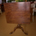 Antique mahogany tilt-top pedestal table.  Approximately 48" square.