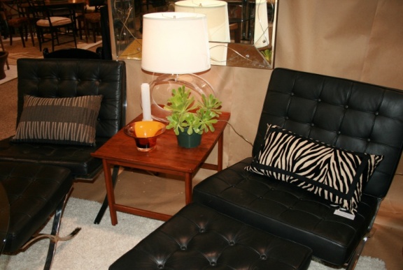 Pair of black leather Barcelona chairs with ottomans