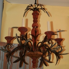 Vintage wood and iron six arm chandelier with decorative wheat design elements.