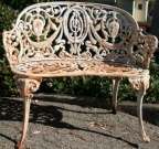 Pair of antique (circa 1880) cast iron garden bench in the Versailles design with neoclassical detailing.
