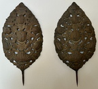 Pair of antique European repousse sconce backs with decorative sunflower detail. The labor intensive metal-working process involves shaping the metal from the back to create the raised intricate design on the front. Each measures 28" high x 14" wid