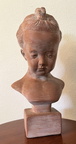 Lovely terracotta colored bust of a small child with delicate features and detail. Measures approximately 8" x 15". $75.