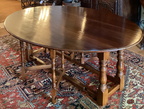 Large antique oval drop leaf table with gate legs, comfortably seats eight people.